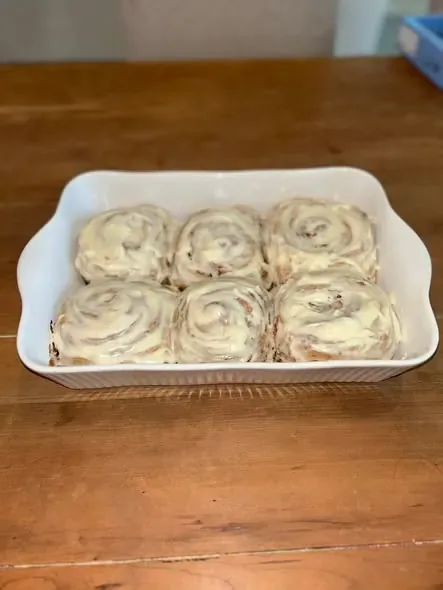 A pan of frosted sourdough cinnamon rolls