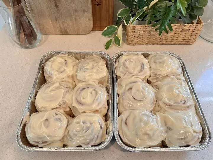 Sourdough cinnamon rolls under thick cream cheese frosting